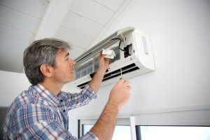 Repairman fixing air conditioner unit